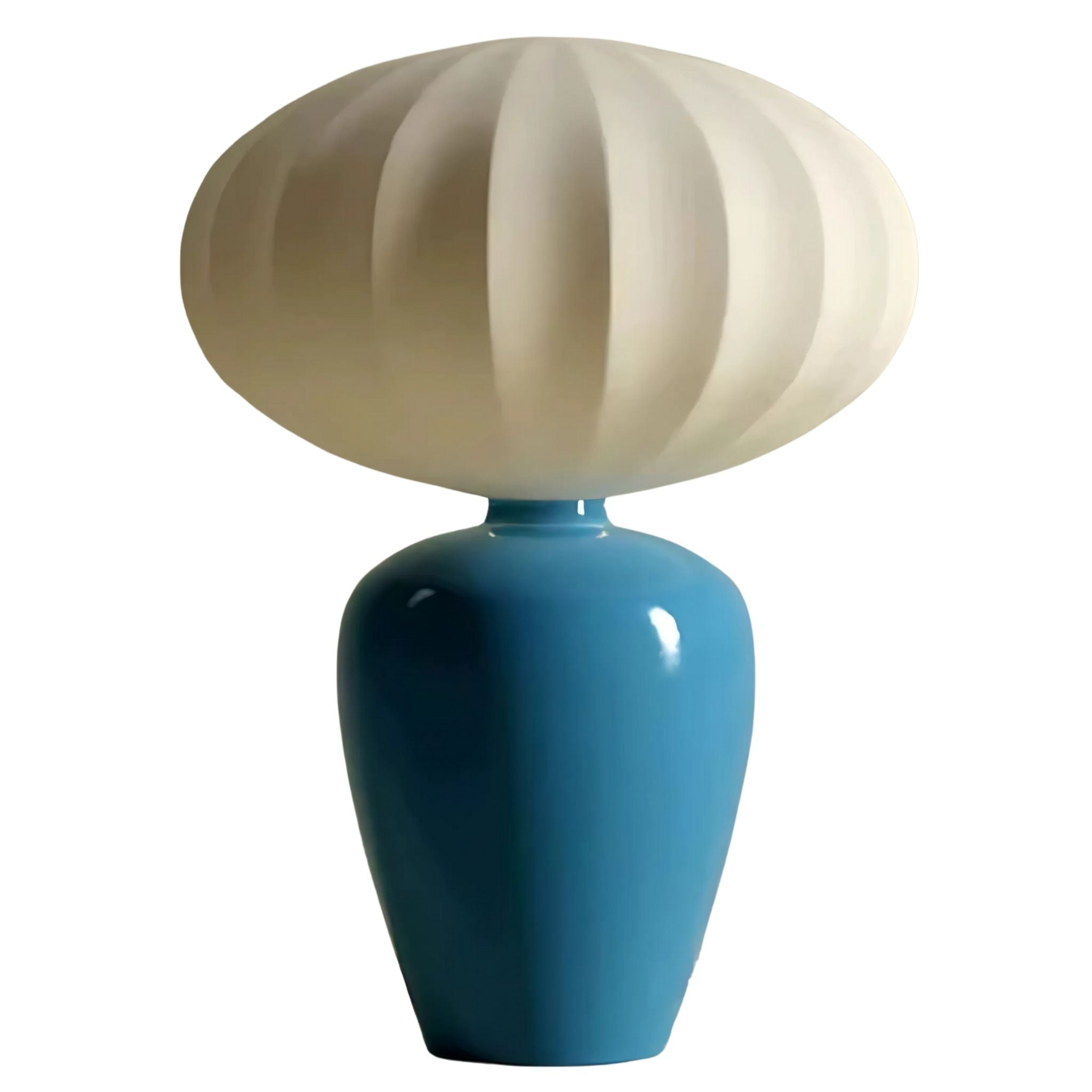 Modern table lamp with blue, ceramic base and a round, white fabric lamp shade.