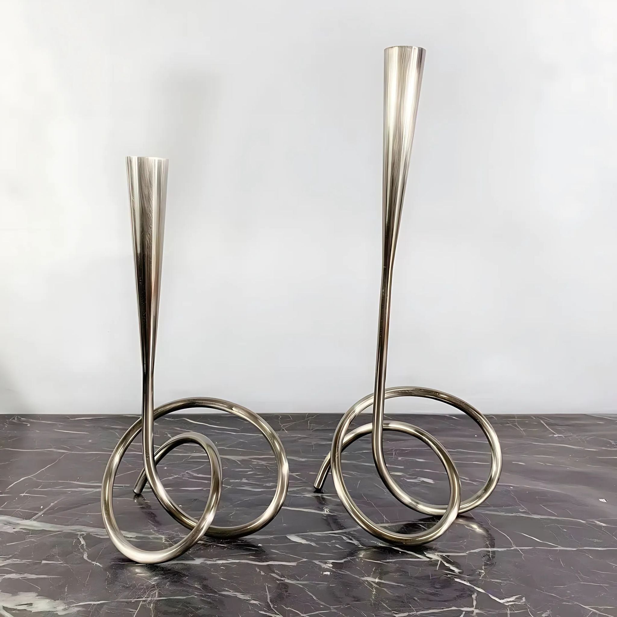 Metal silver decorative candlestick holders.