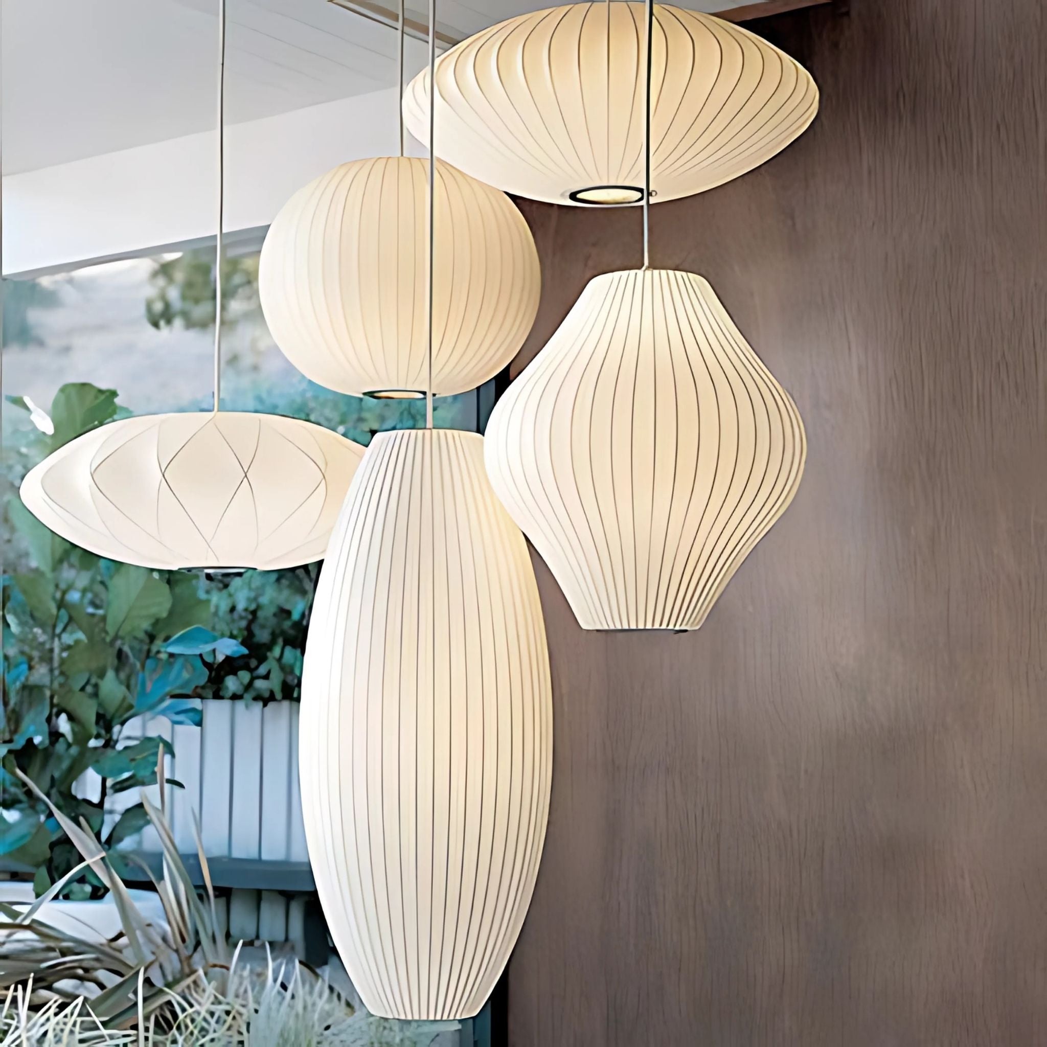 Geometrical, pendant lamps with white, fabric lamp shades.