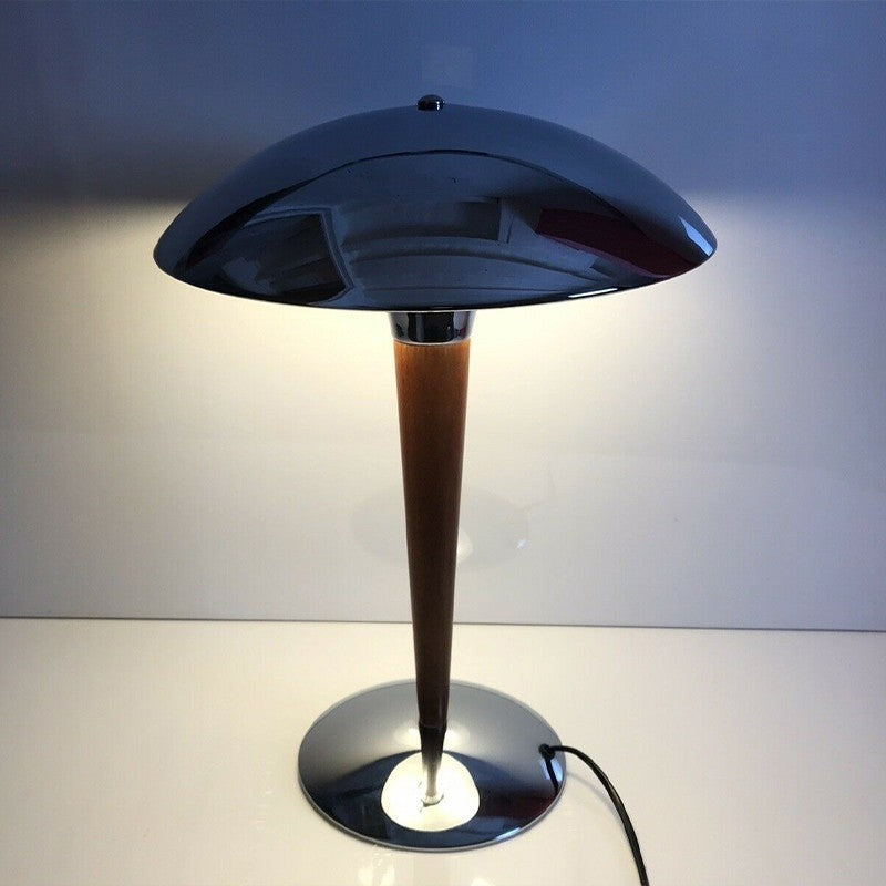 Table lamp with silver metallic base and lamp shade.