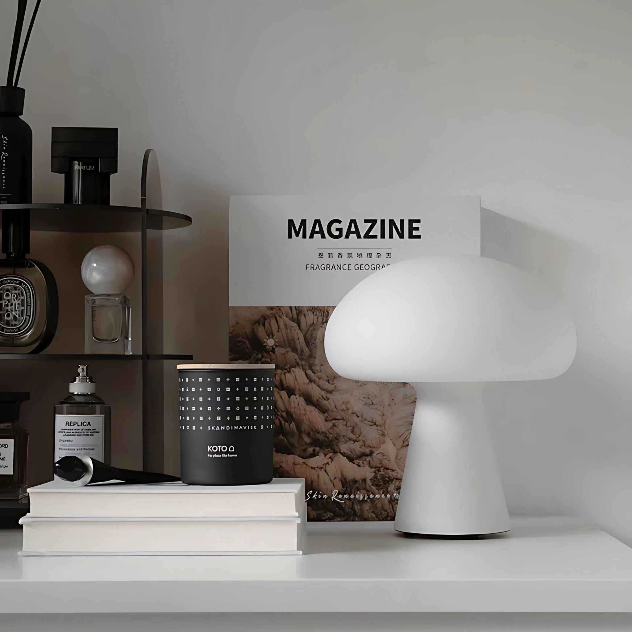 White, Scandinavian design cordless table lamp on counter top with various home décor items.
