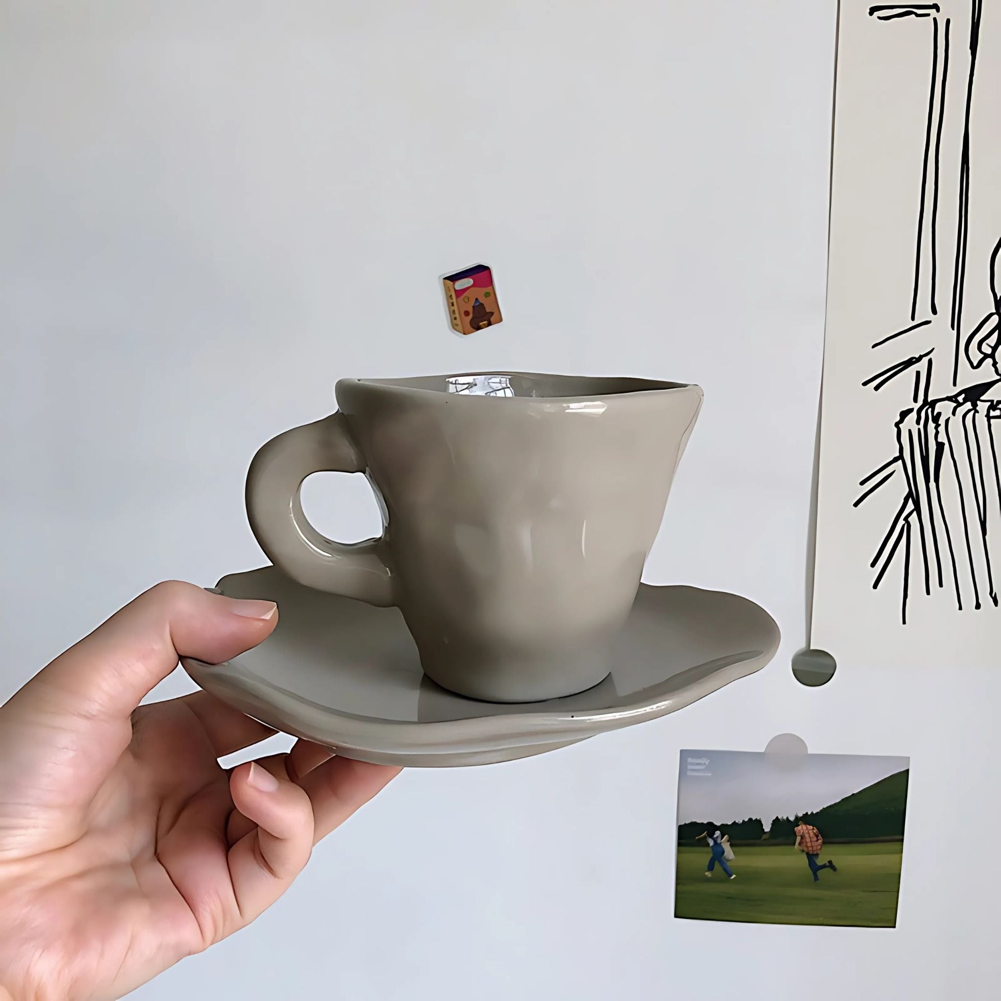 Cute, grey, ceramic coffee mug and saucer.