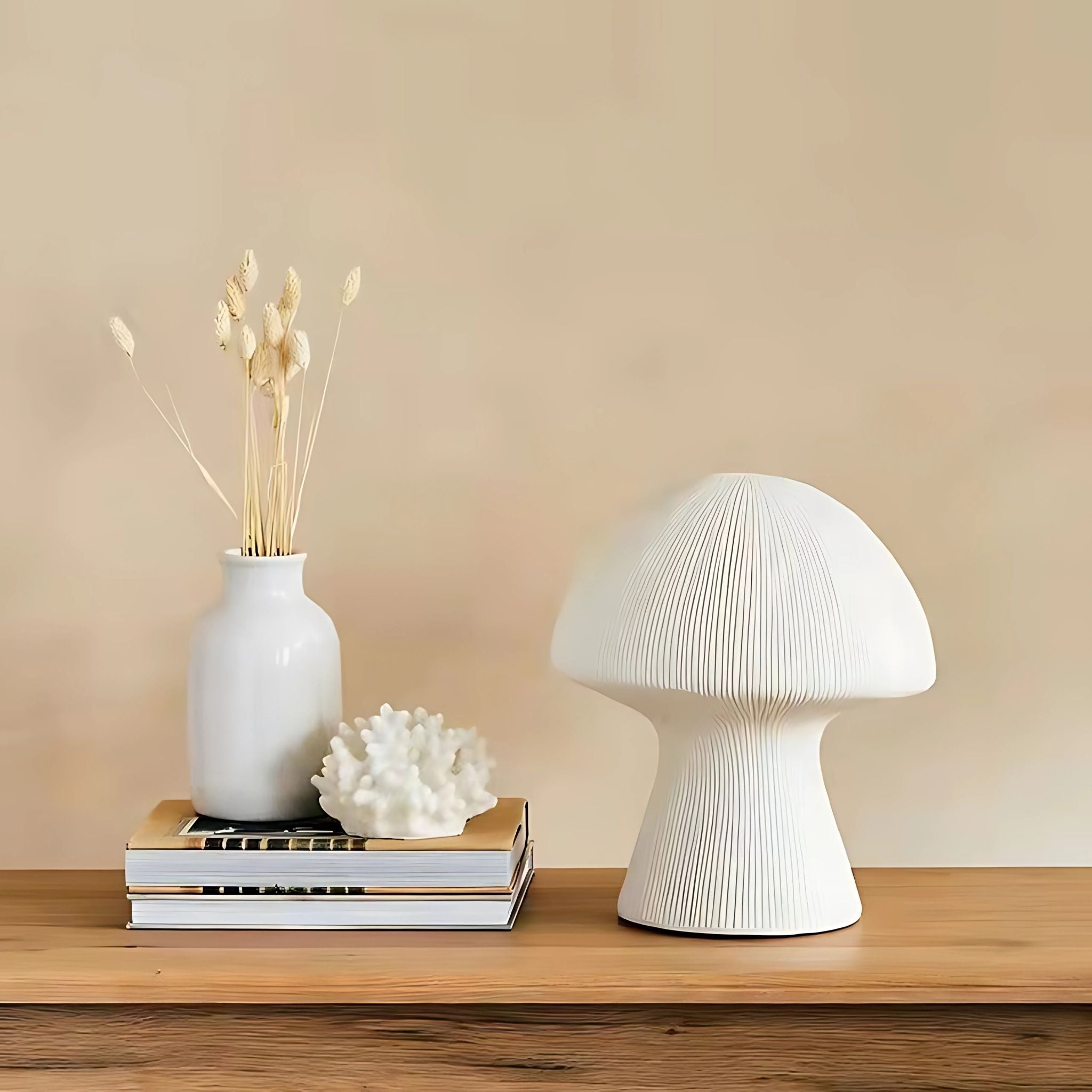 Nordic, decorative, ceramic table lamp with textured lines on wooden tabletop with home decor items and books.