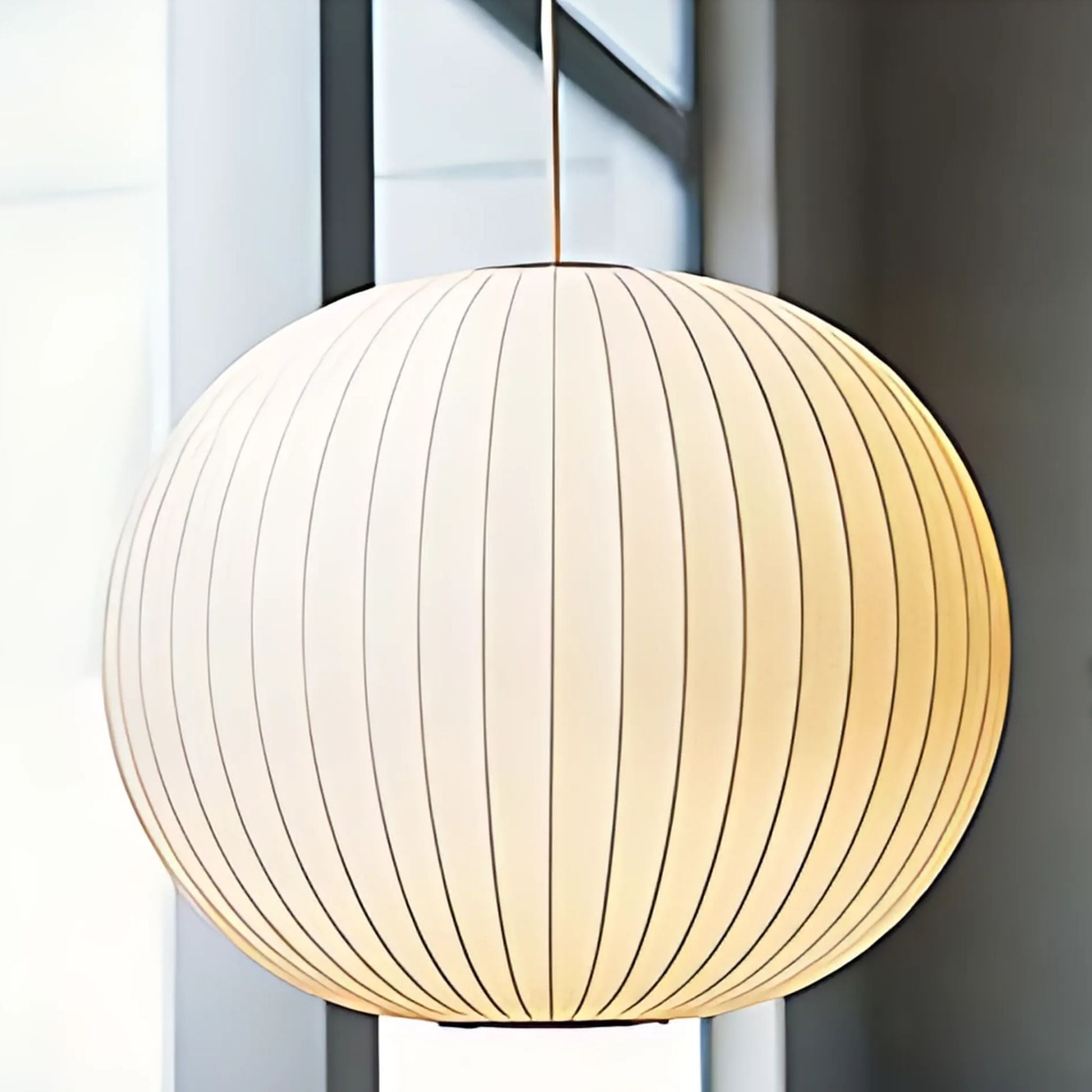 Round, white, fabric pendant lamp.