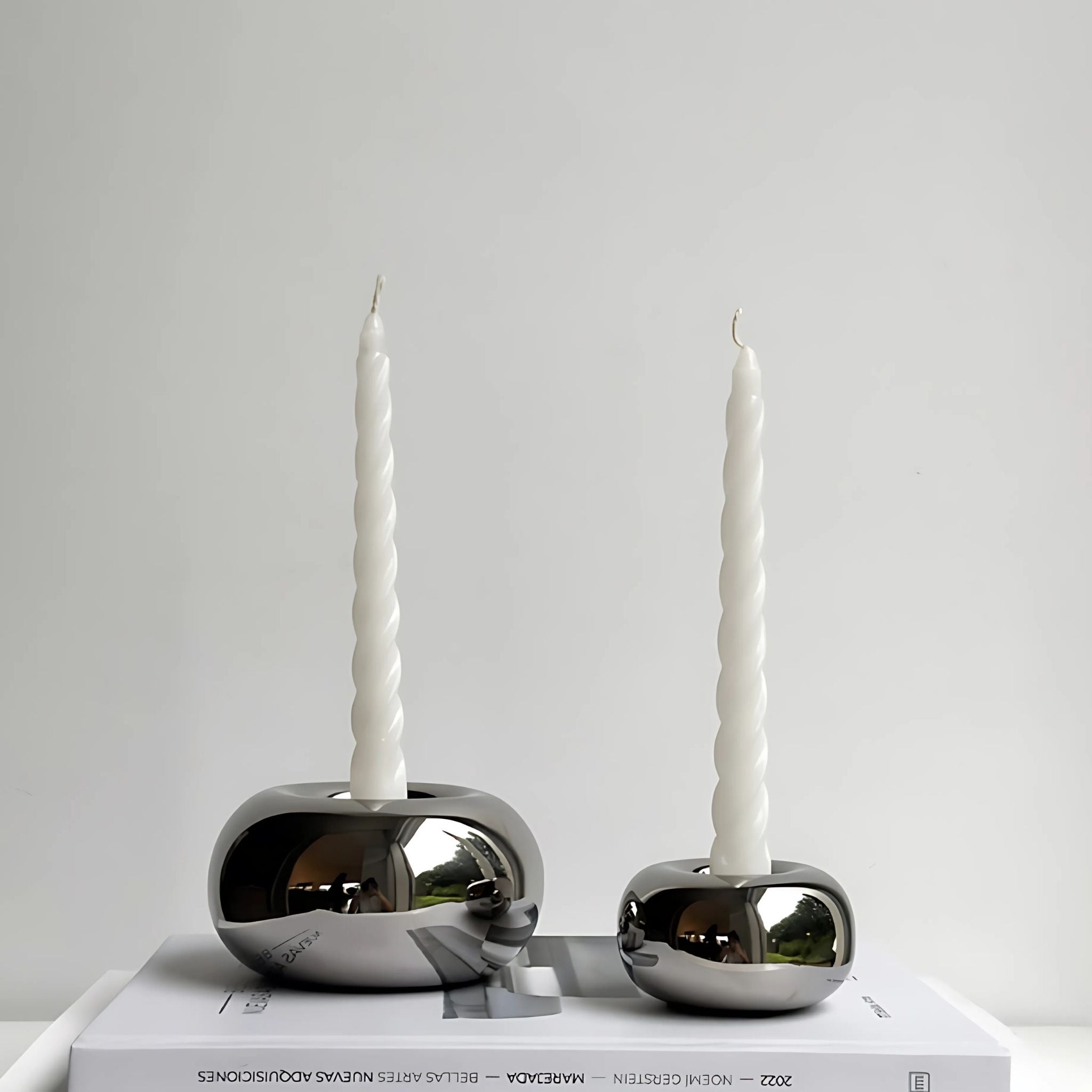 Round, silver candleholders.