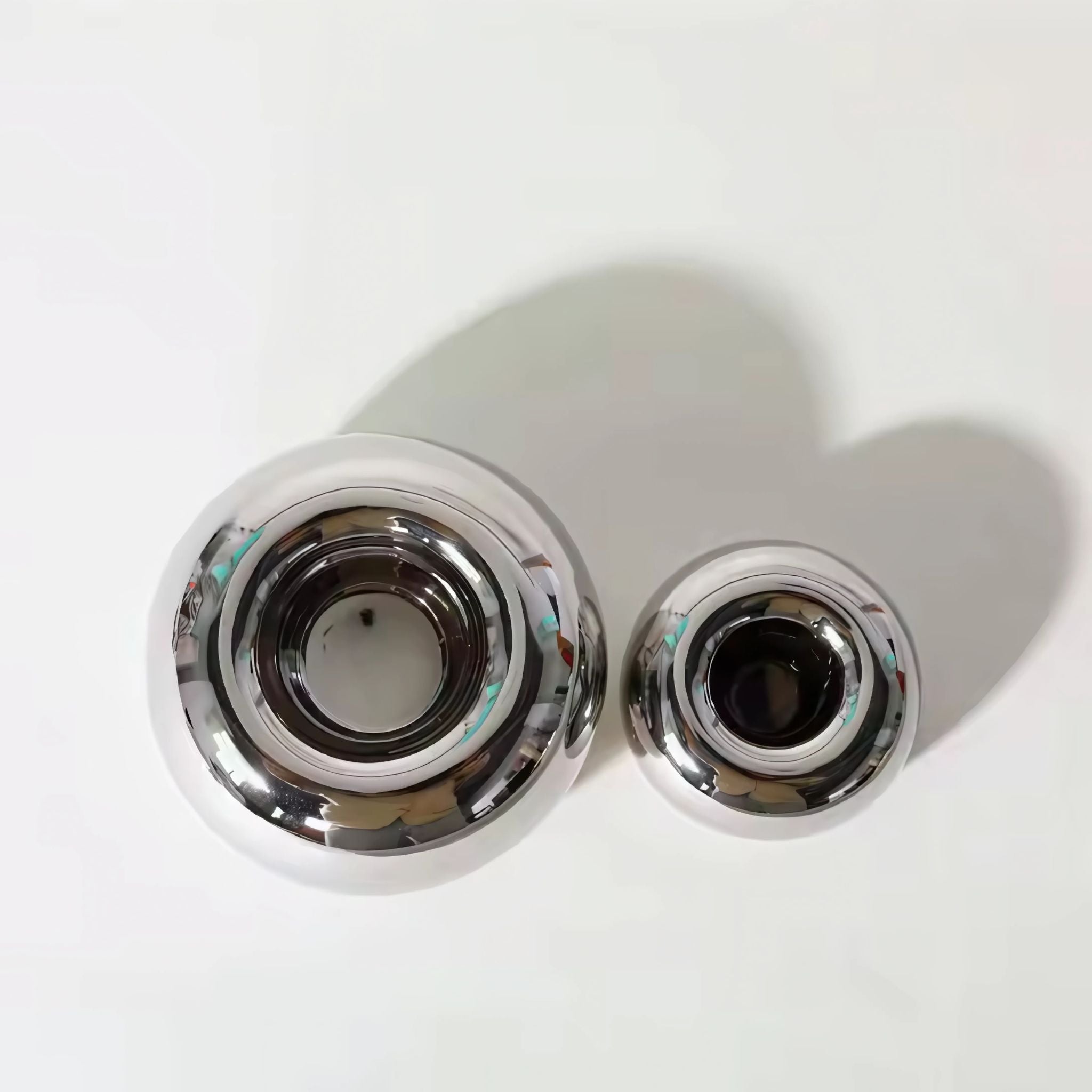 Two sizes of silver chrome candlestick holders table decor.