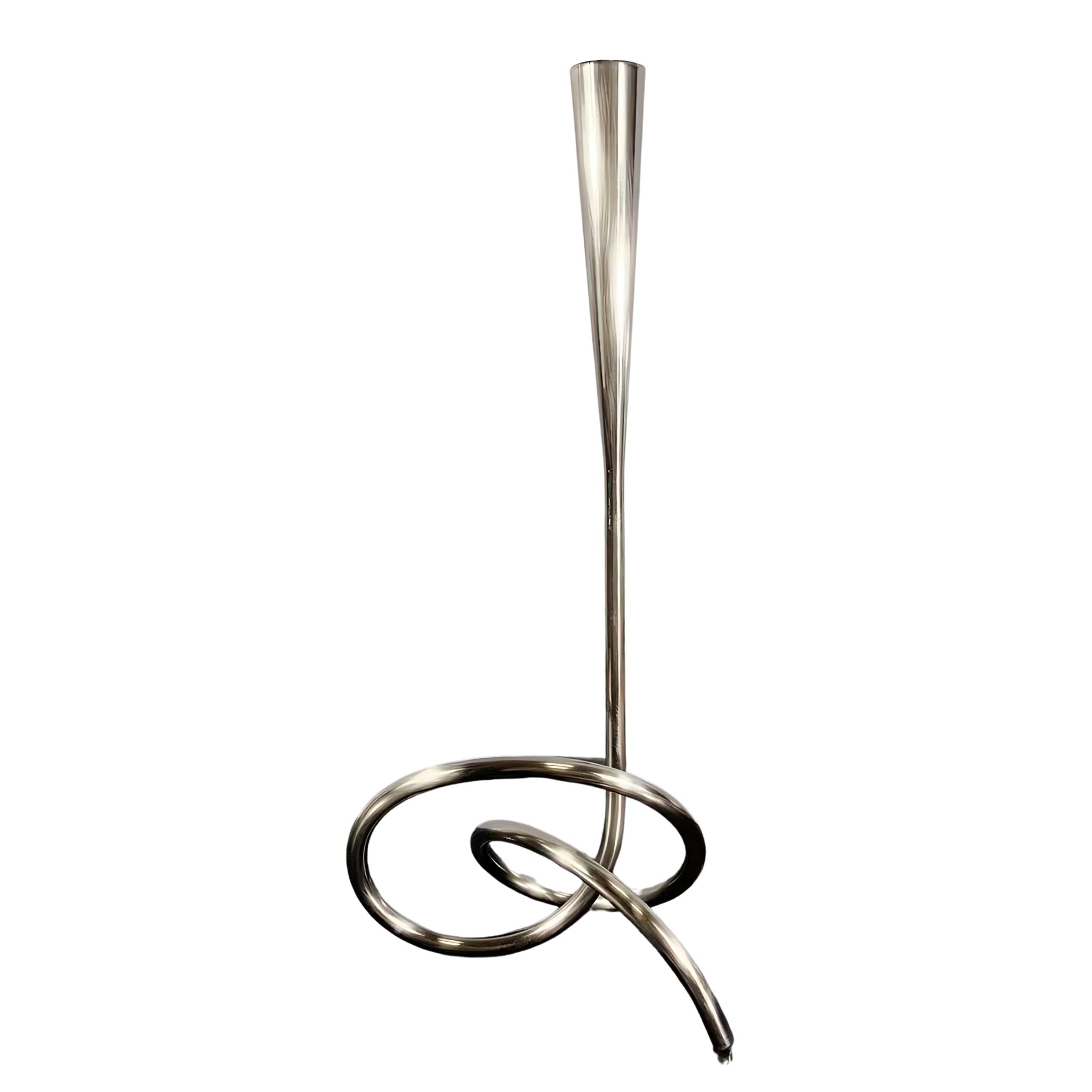 Silver metallic sculptural candlestick holder.