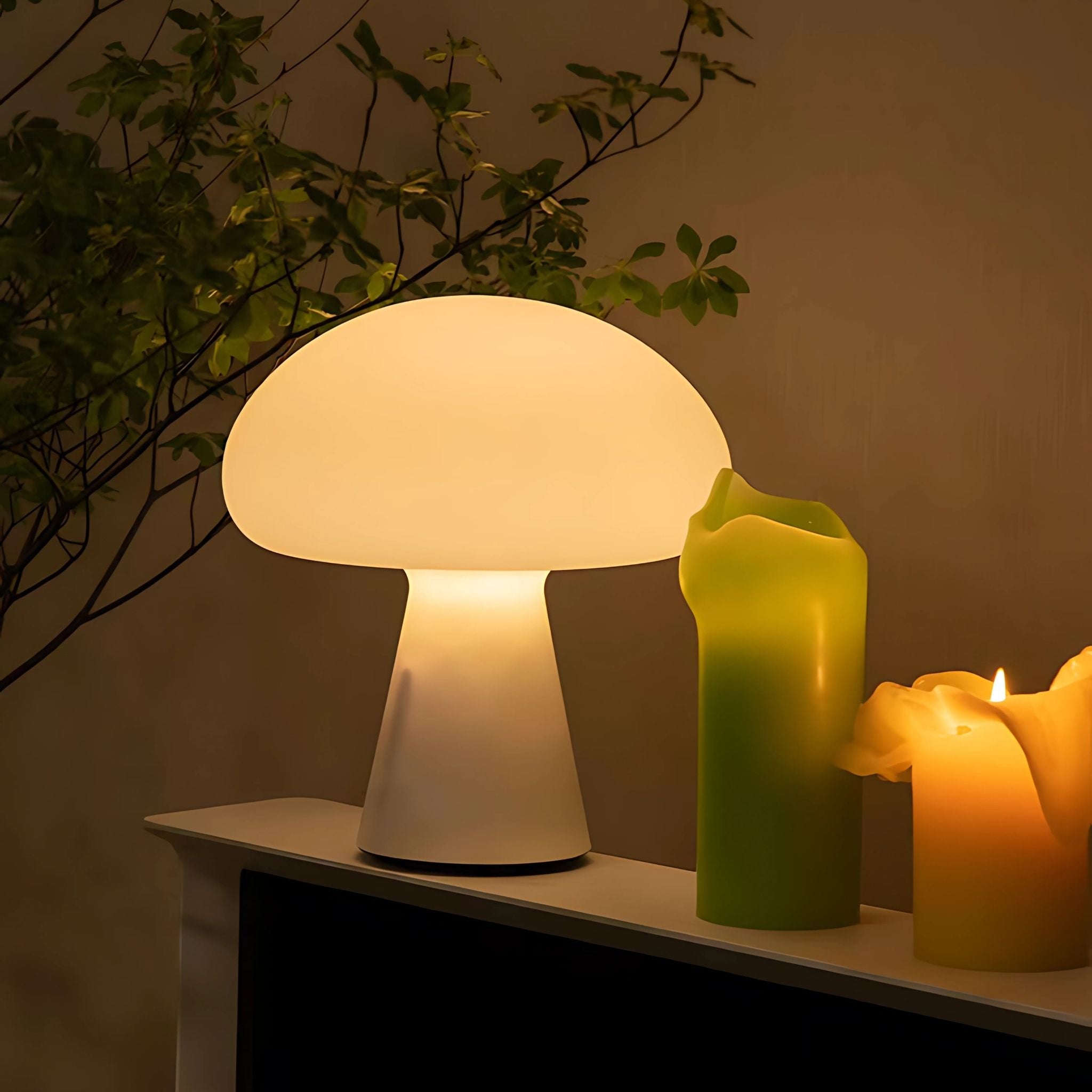 Glowing cordless lamp and candles on top of shelf.