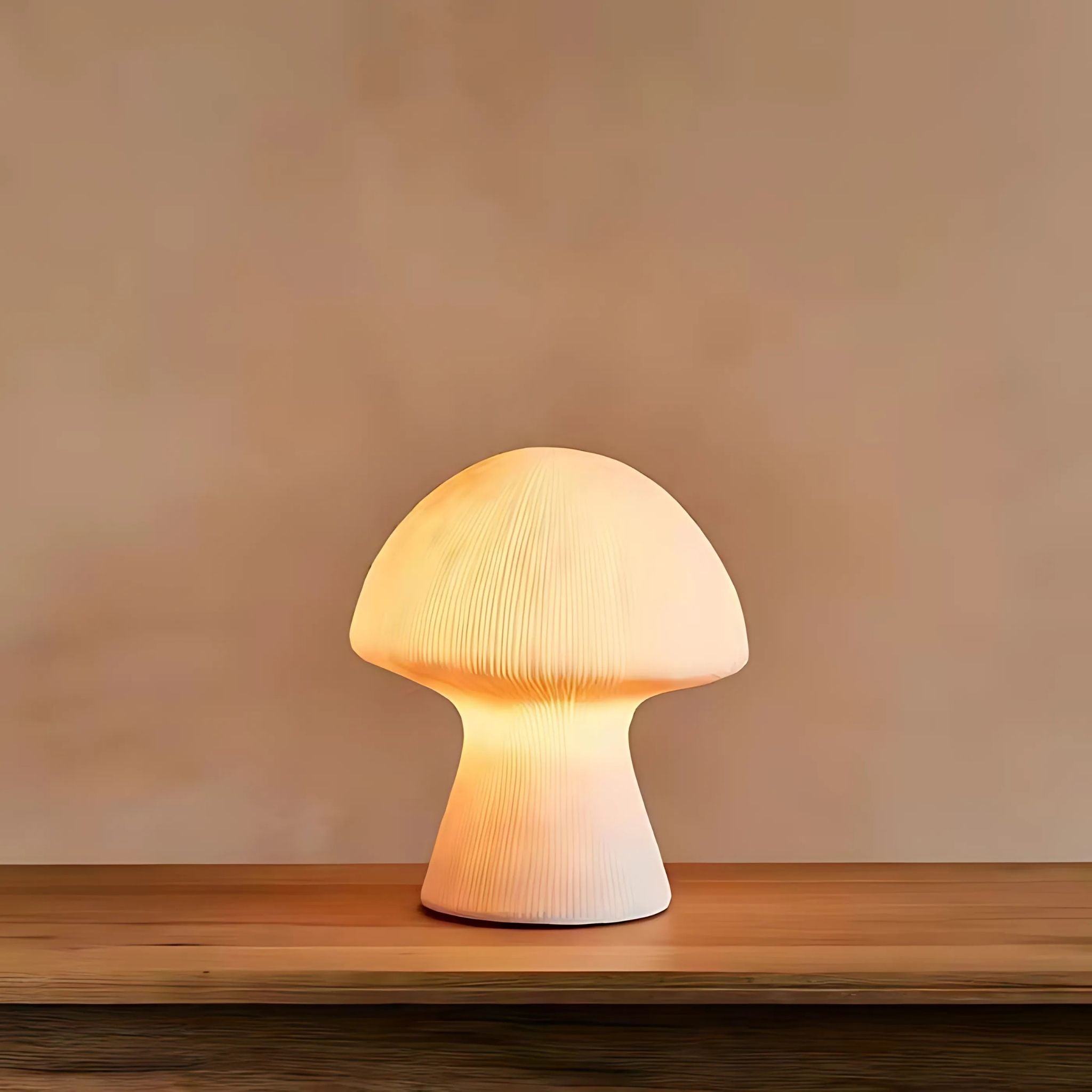 Glowing, modern table lamp on top of wooden table.