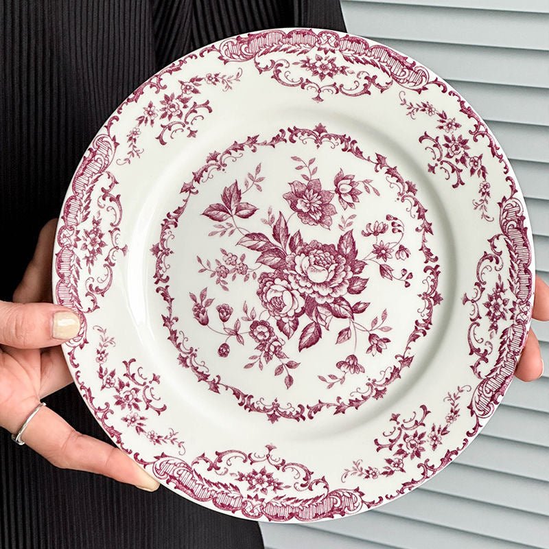 Elegant porcelain dinner plate with red floral design.