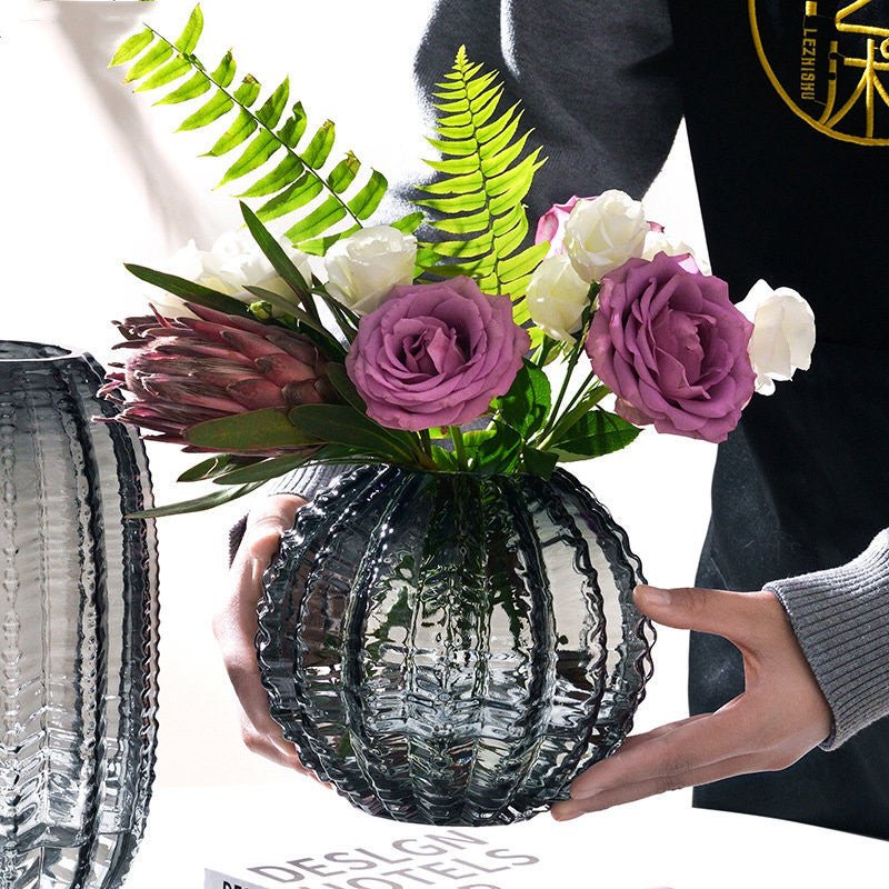 Decorative grey textured round glass flower vase.