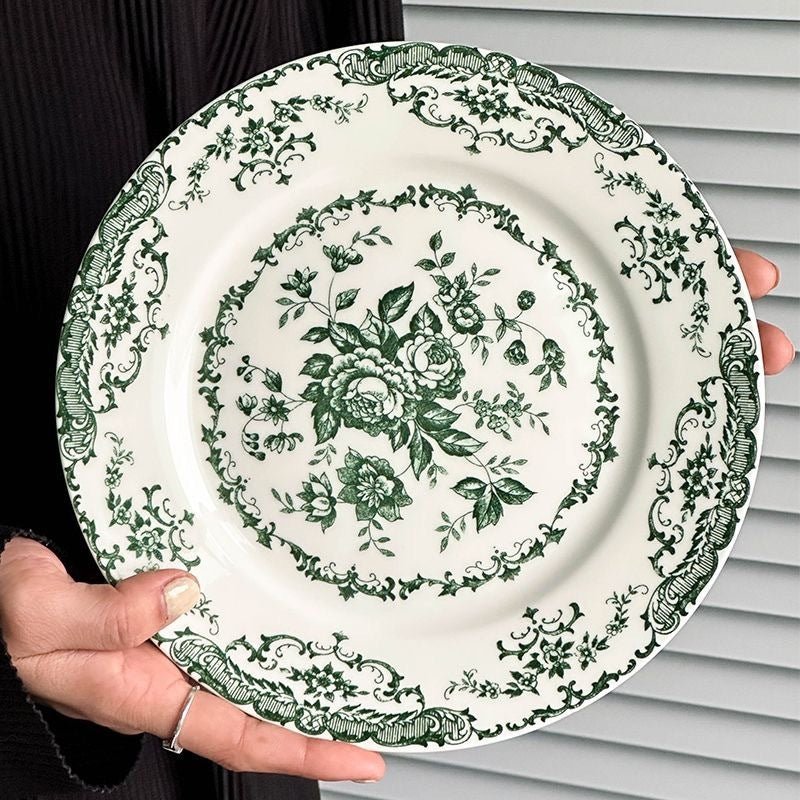 Porcelain dinner plate with green floral design.