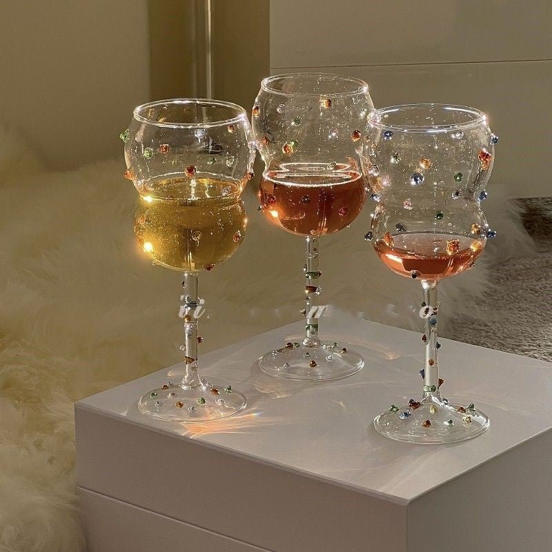 Cute, elegant glass stemware drinking goblets with colourful gemstones.