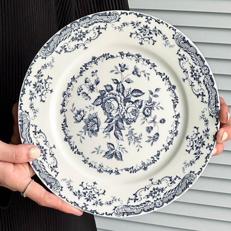 Elegant porcelain dinner plate with blue floral design.