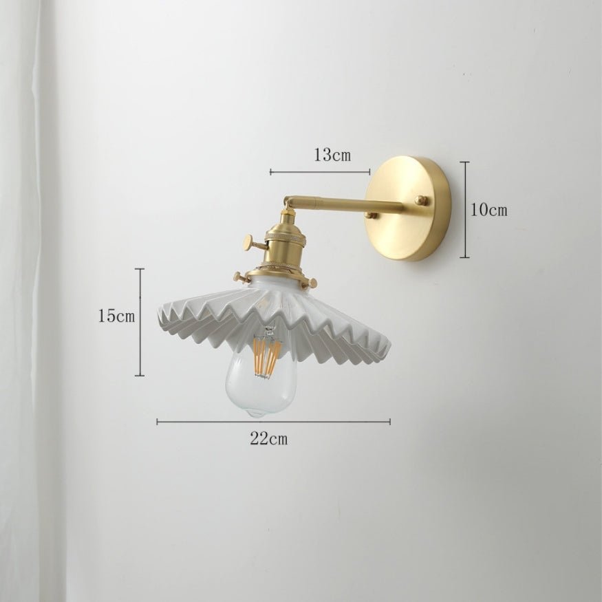 Gold bedside wall lamp with umbrella white glass lamp shade.