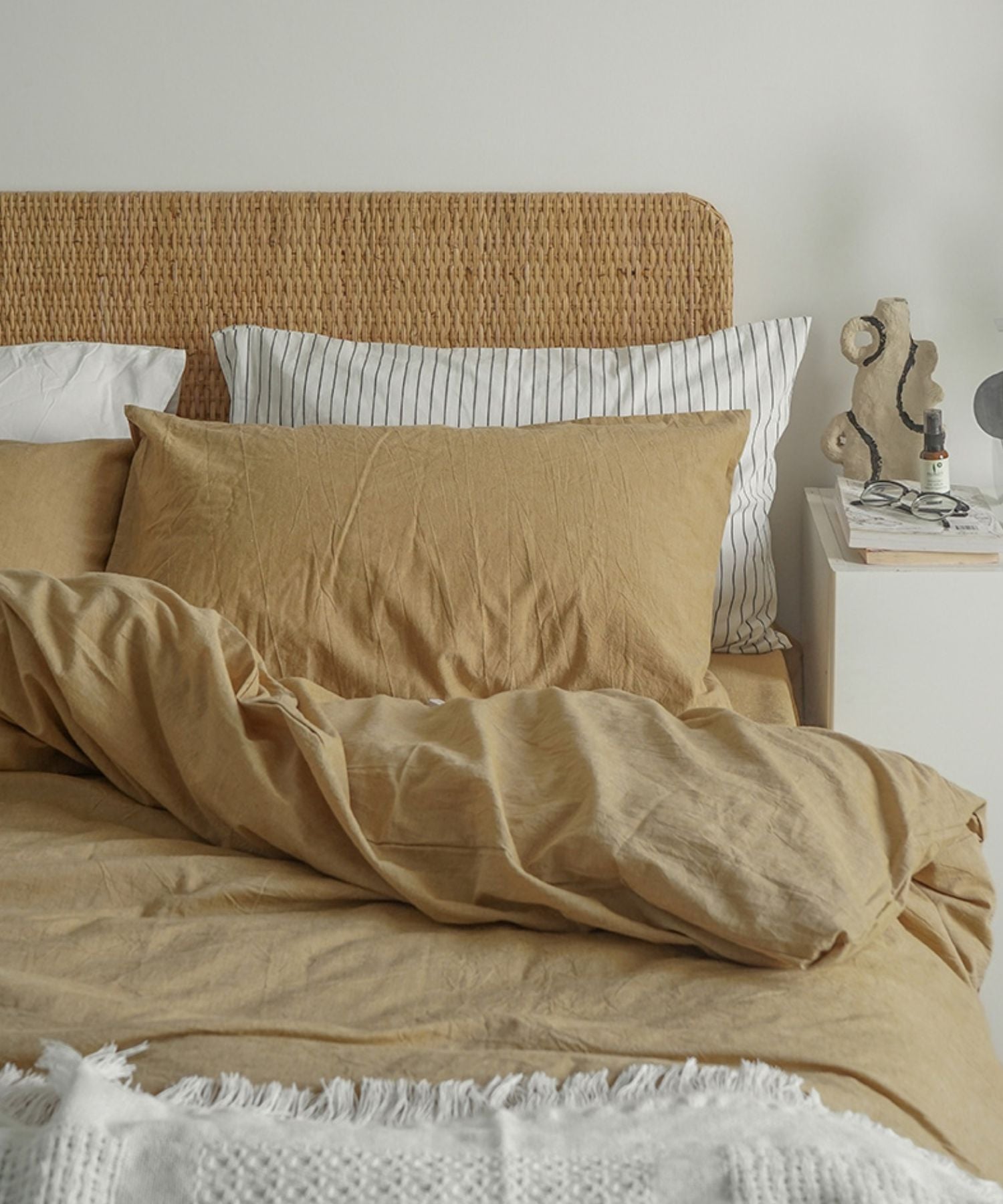 Beige crisp textile bed linen bedding sheets.