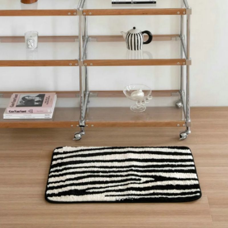 Black and white zebra animal print stripe floor mat.