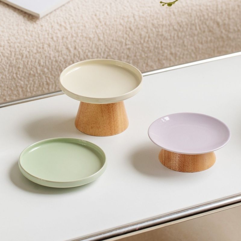 Cute pastel ceramic plates with wooden base serving trays.