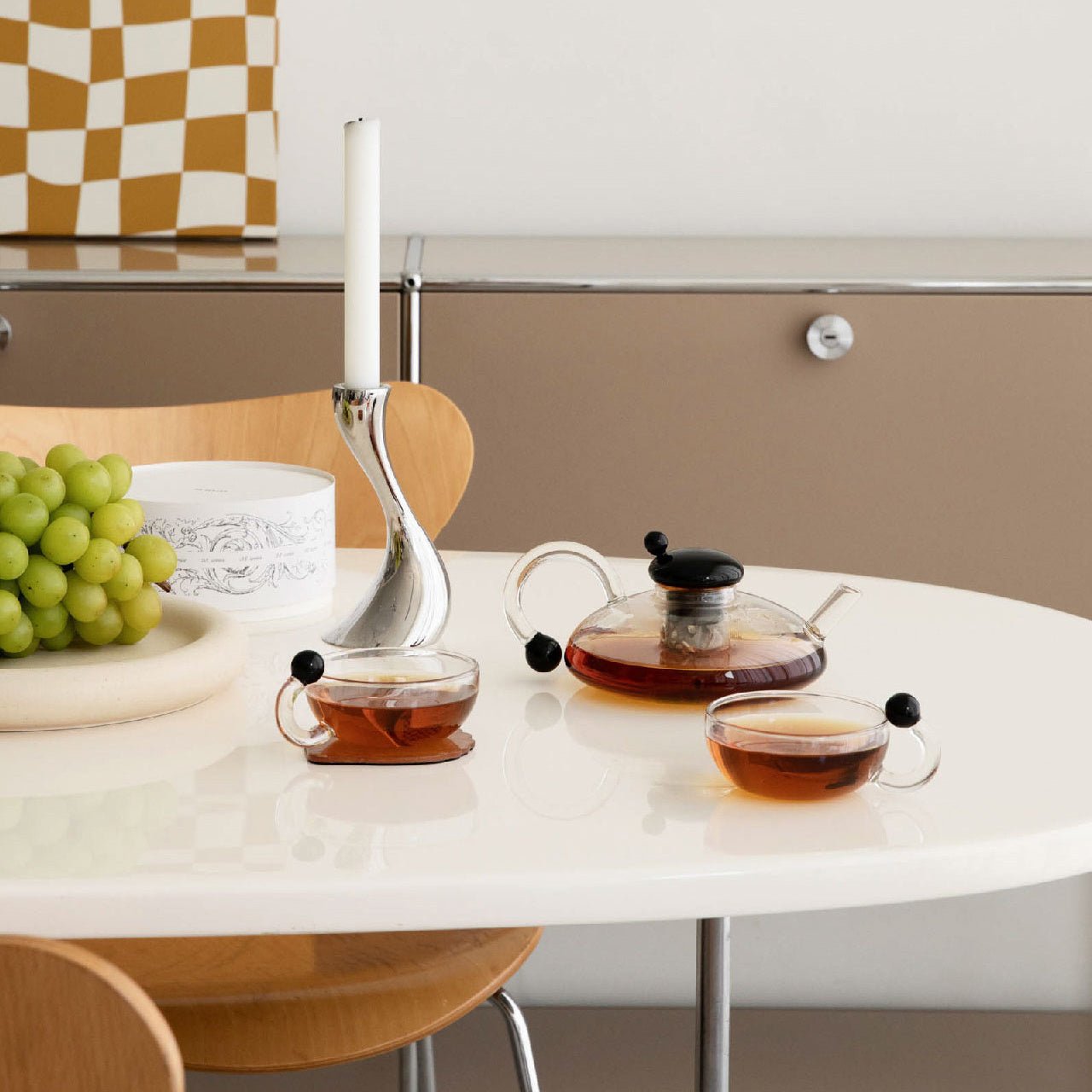 Modern glass tableware full tea set on a dinner table.