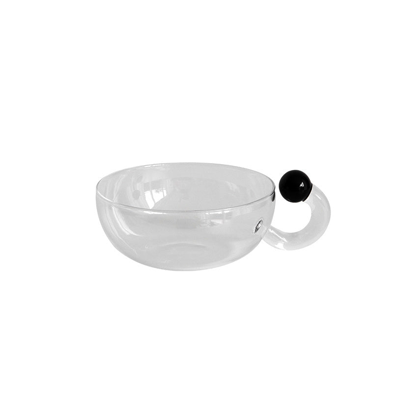 Modern teacup glass with black ball accent.