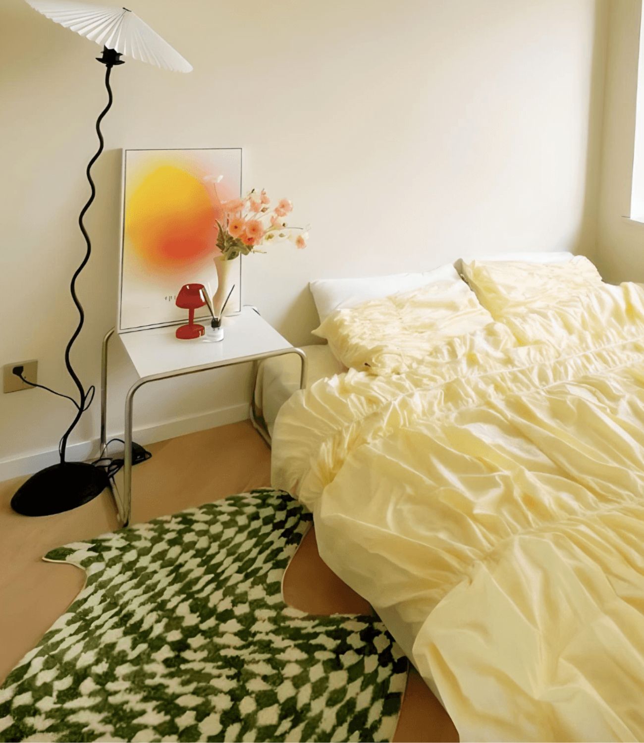 Funky bedroom decor wiggle stem lamp, yellow sheets and green white checkerboard floor rug.