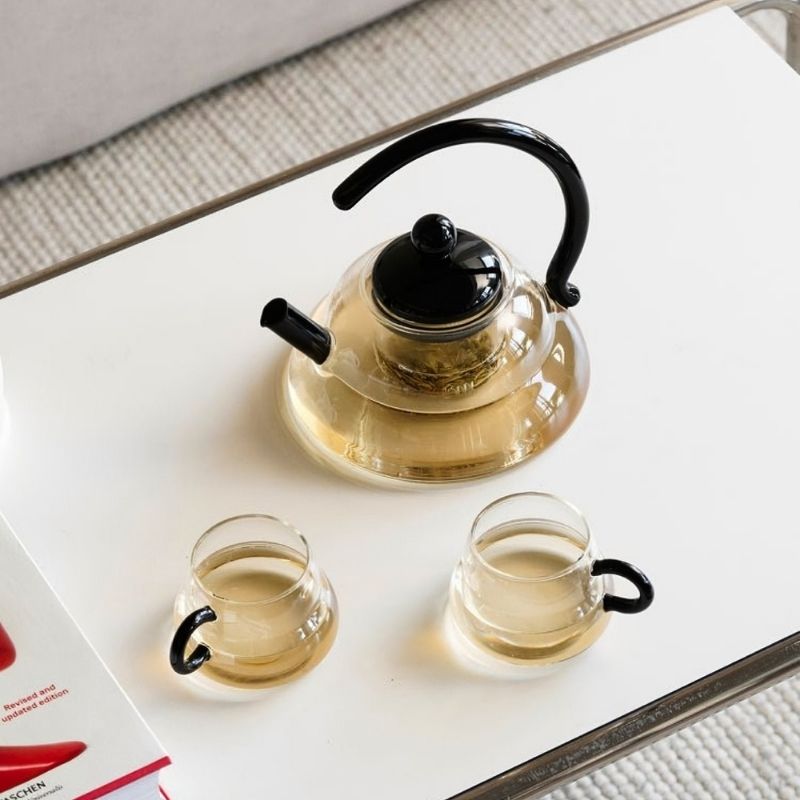 Modern glass tea can and cups for coffee table.