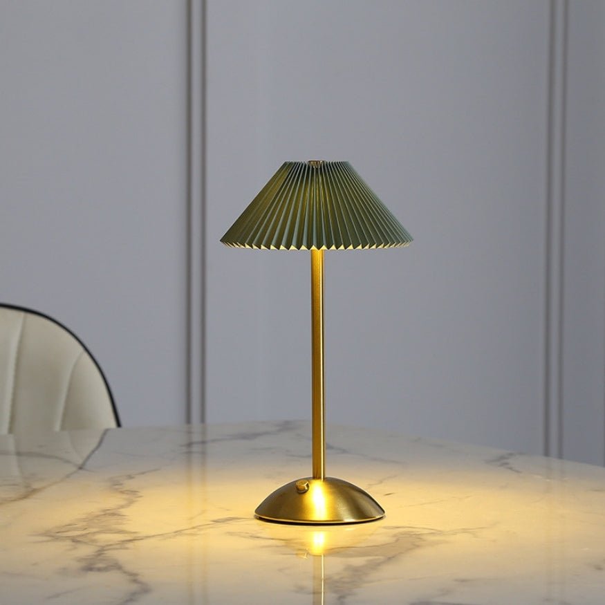 Green shade gold metal portable table lamp.