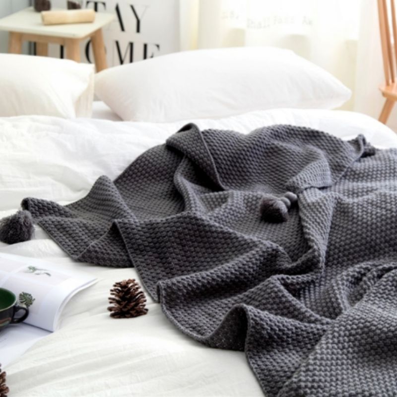 Grey knit tassel throw blanket.