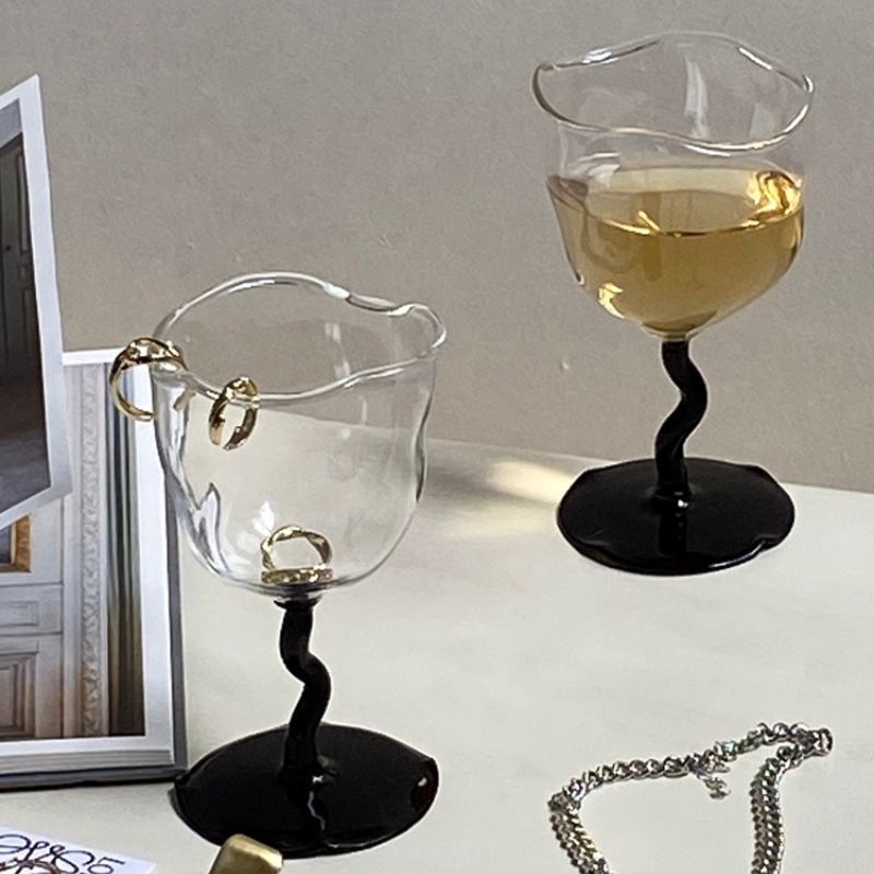 Irregular wine glass goblets with black stem.