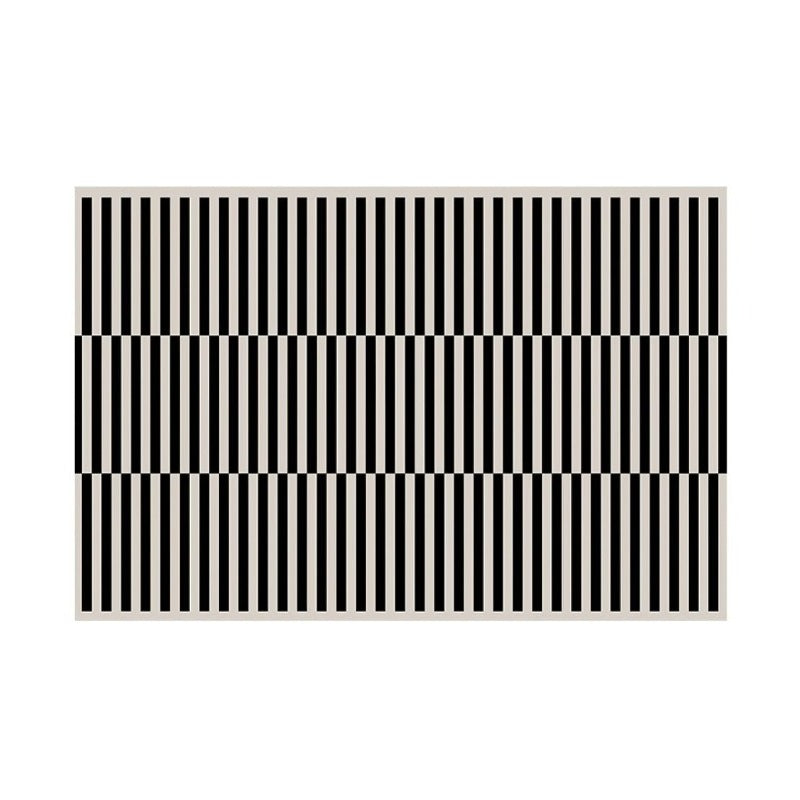 Large square area floor carpet with black and white stripes.
