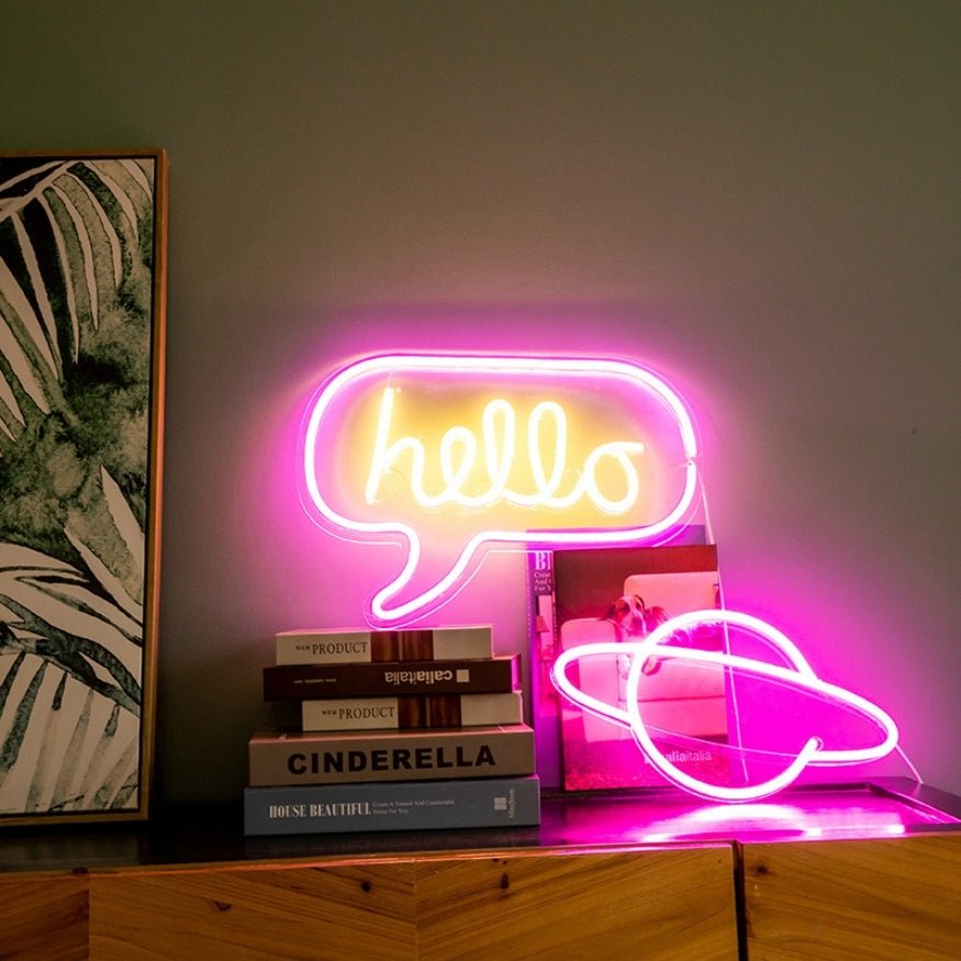 Glowing LED sign lights, pink "Hello" and planet.