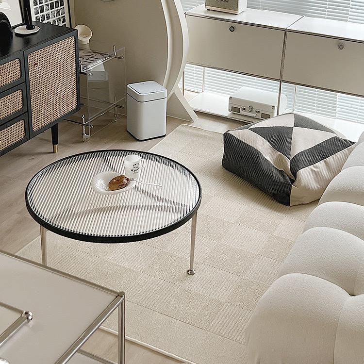 Living room with modern decor and a large beige floor carpet with grid design, coffee table, white sofa and nordic interiors.