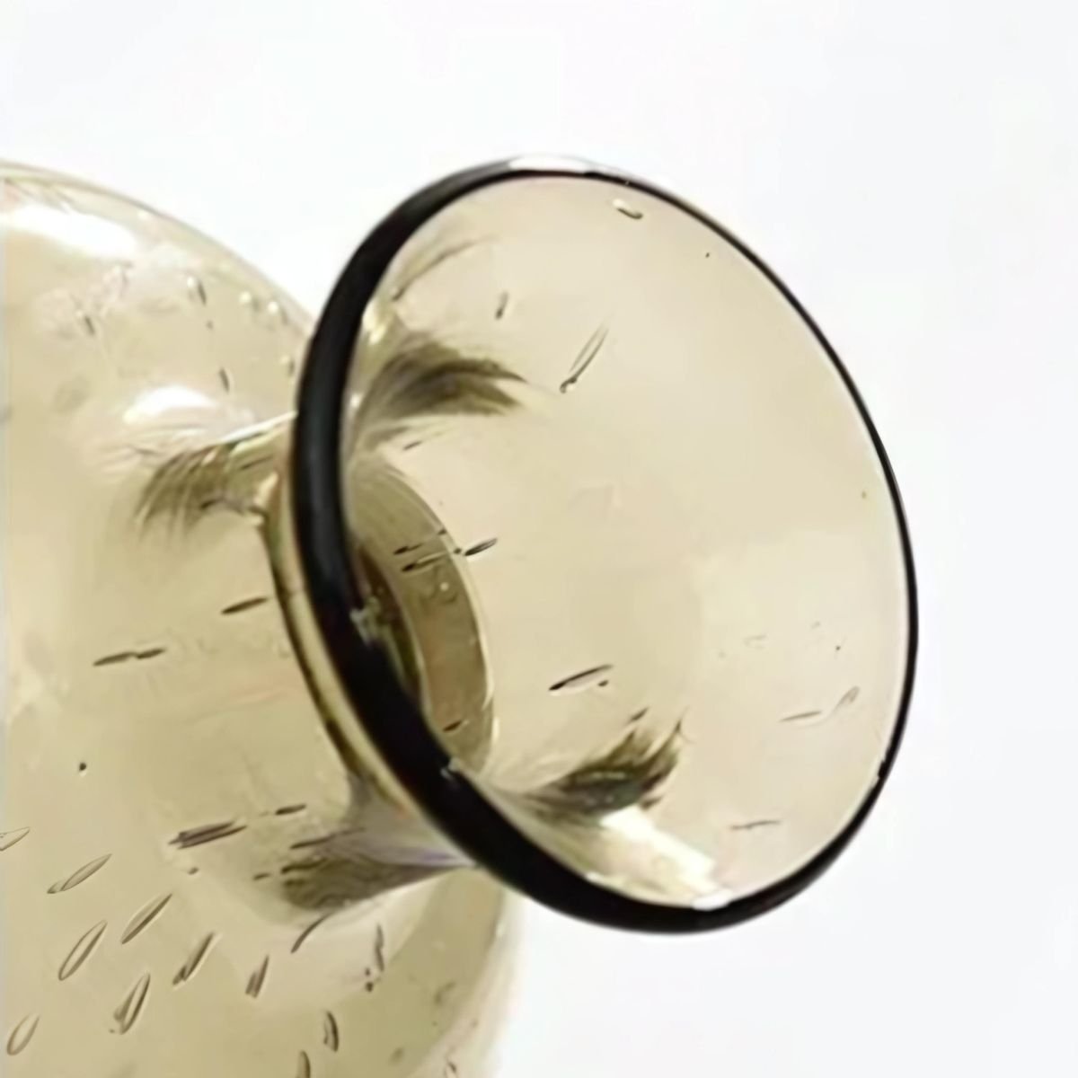 Closeup image of glass vase mouth with air bubbles.