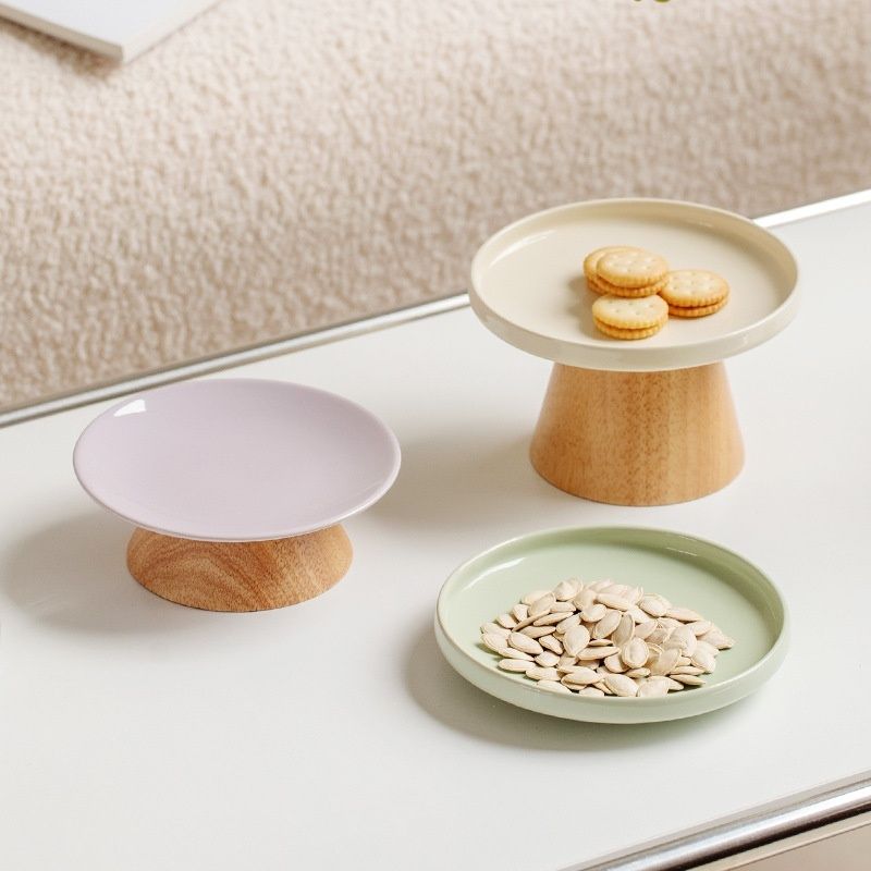 Pastel ceramic plates with wooden base.