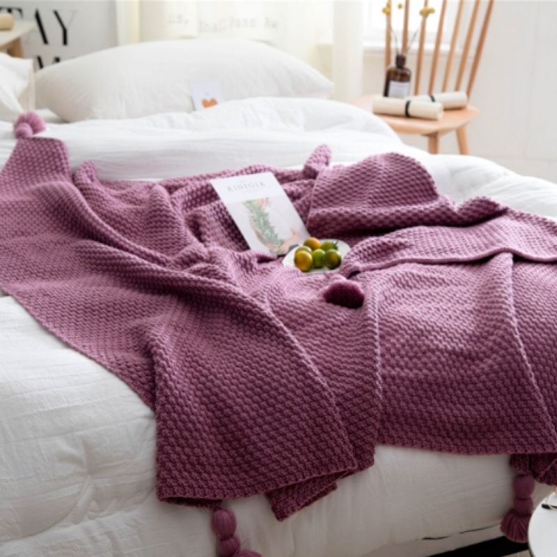 Purple knit tassel throw blanket.