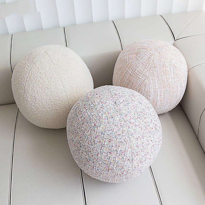 Decorative ball cushions on sofa.