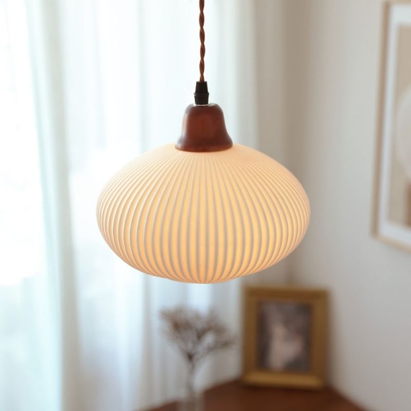 Round, white pumpkin shape pendant lamp.