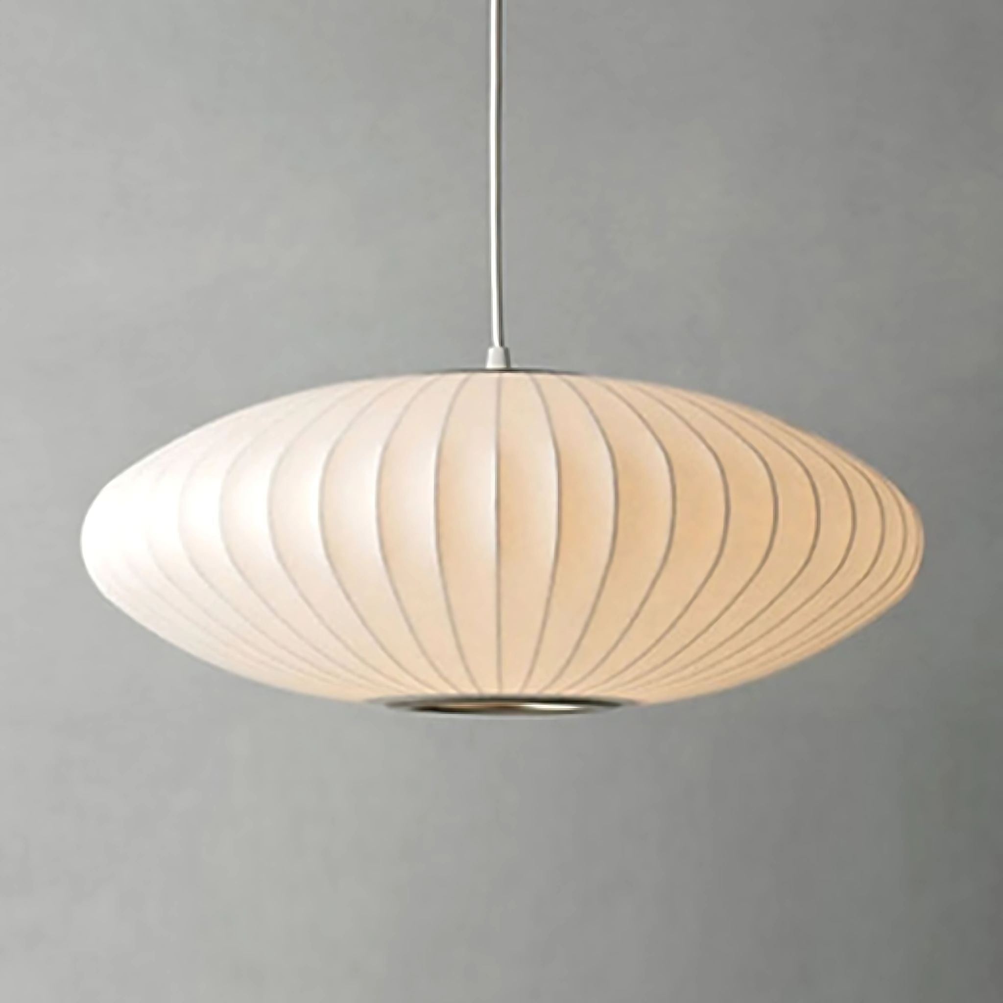 White, fabric ceiling light in saucer shape.