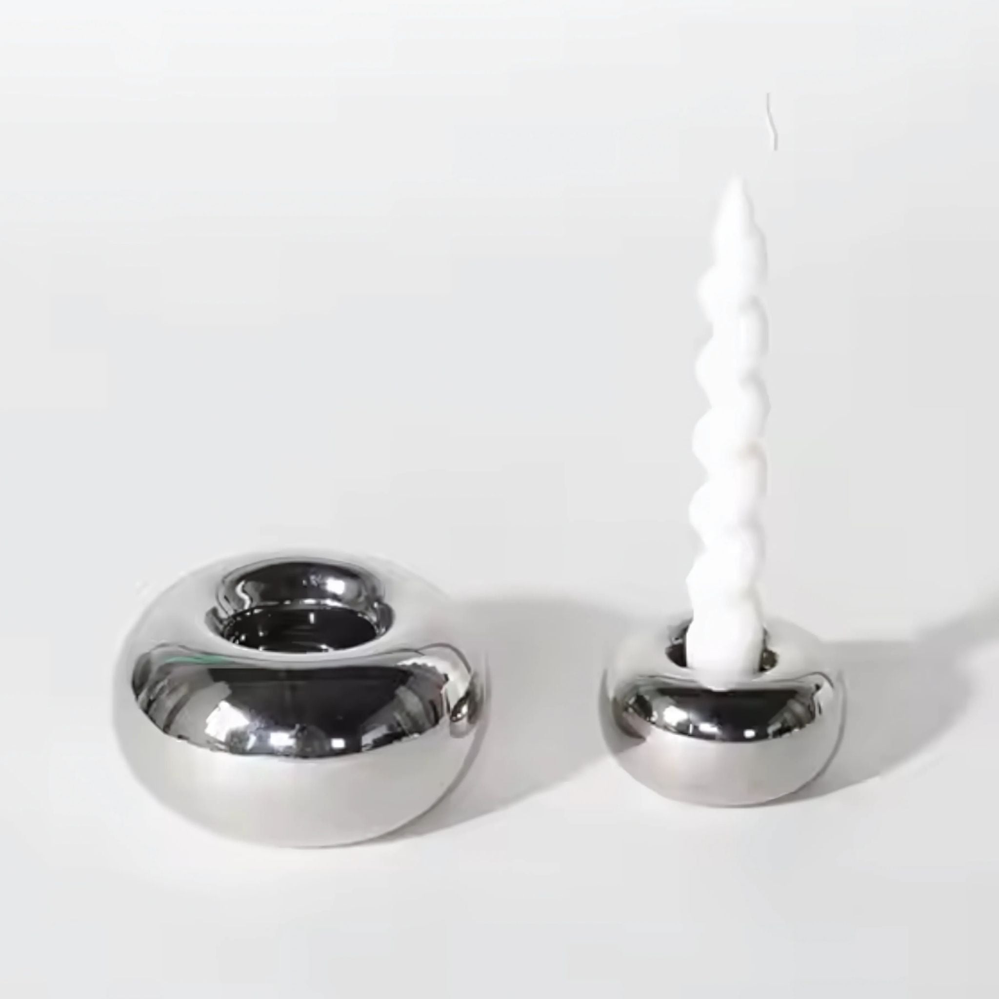 Two, round, silver chrome candlestick holders home décor.