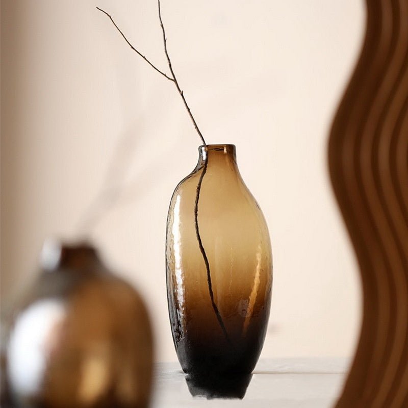 Brown, glass, decorative vase with a tree branch.