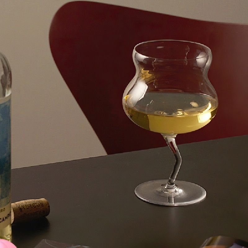 Asymmetrical wavy stem glassware drinking glass.