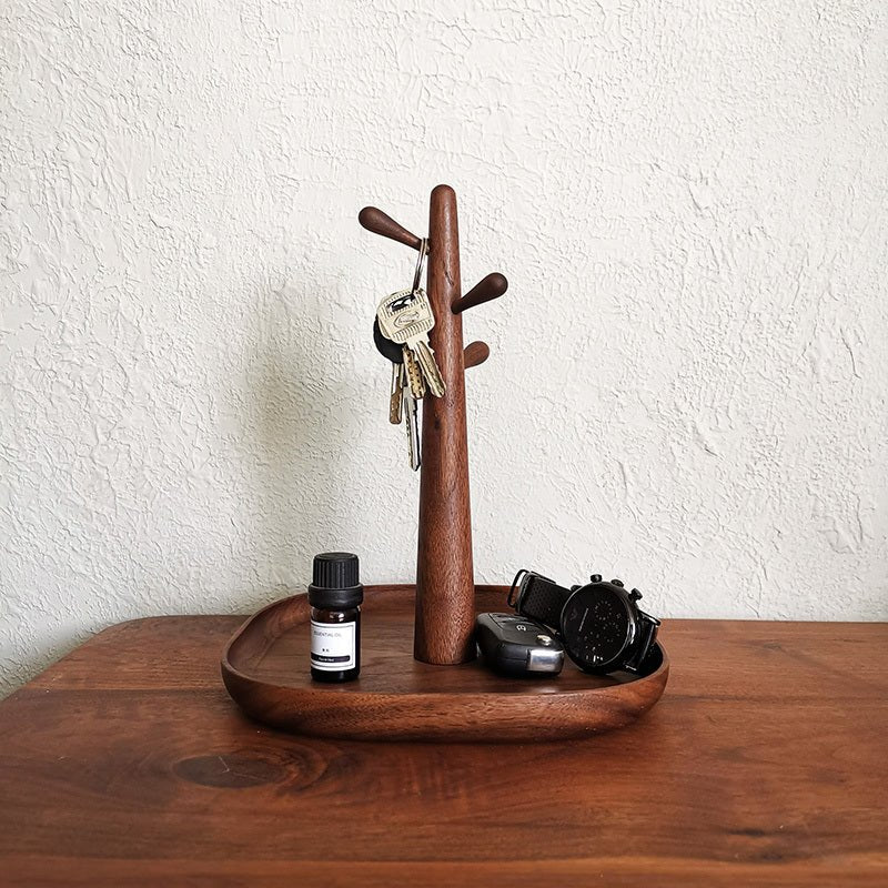 Wooden brown table tray and key rack holding keys and other items.