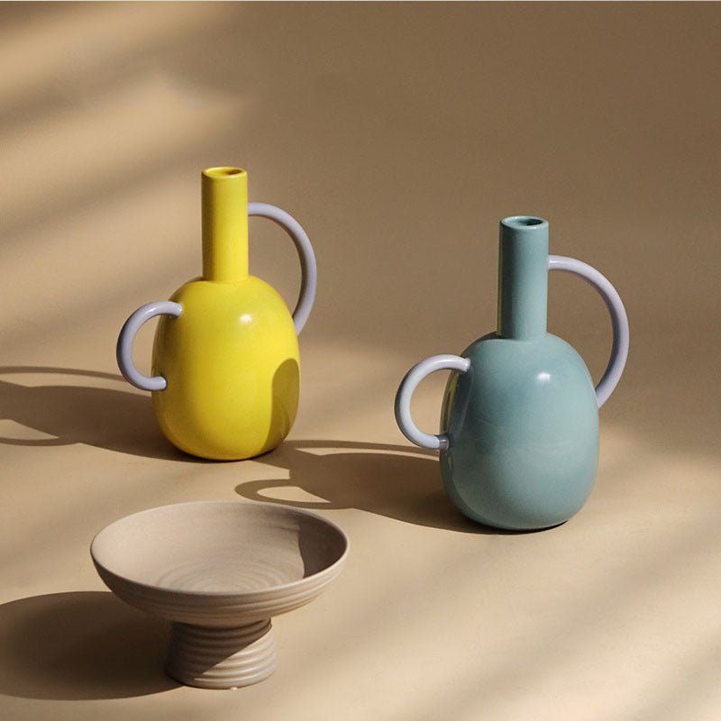 A yellow and blue bottle pitcher vases with a bowl.