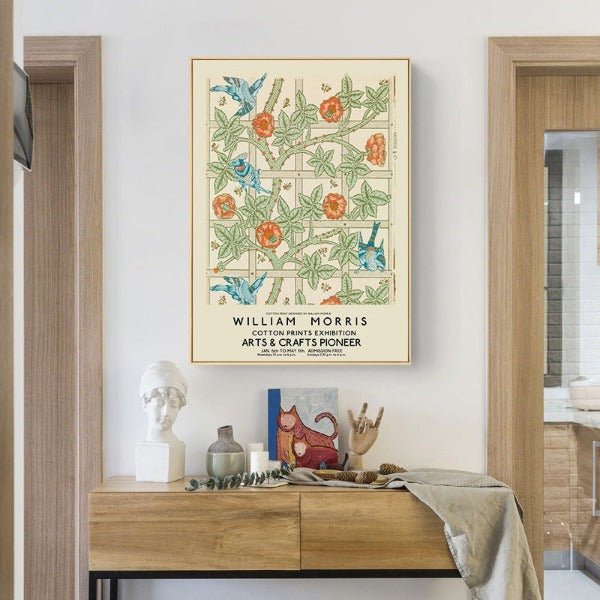 A classic vintage art William Morris flower print poster hanging on a wall above a wooden table with modern, Nordic interiors.