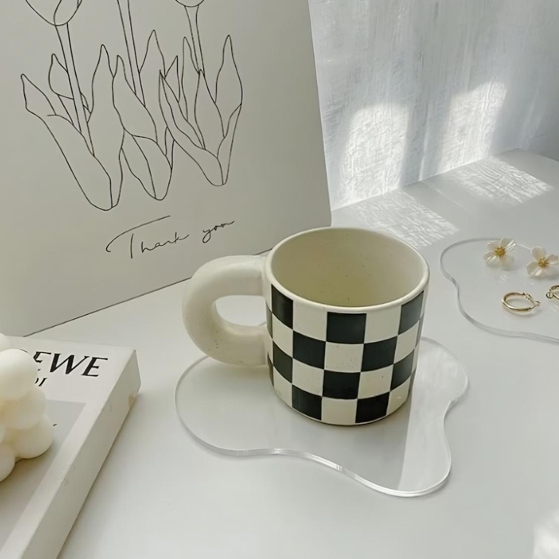 Black white check mug with chunky handle on acrylic coaster