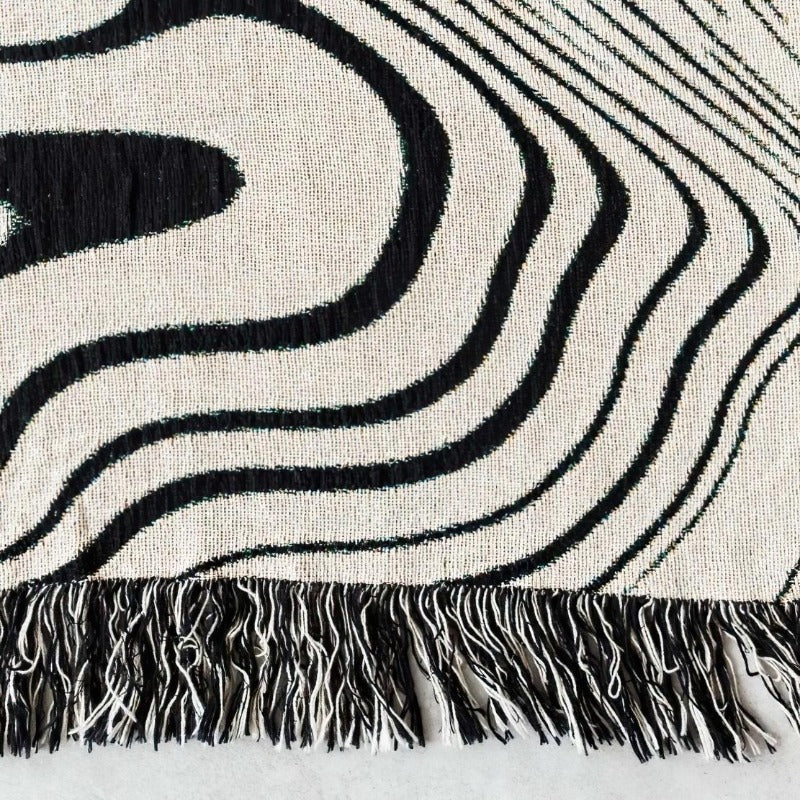 Black & white swirl lines tassel blanket close-up