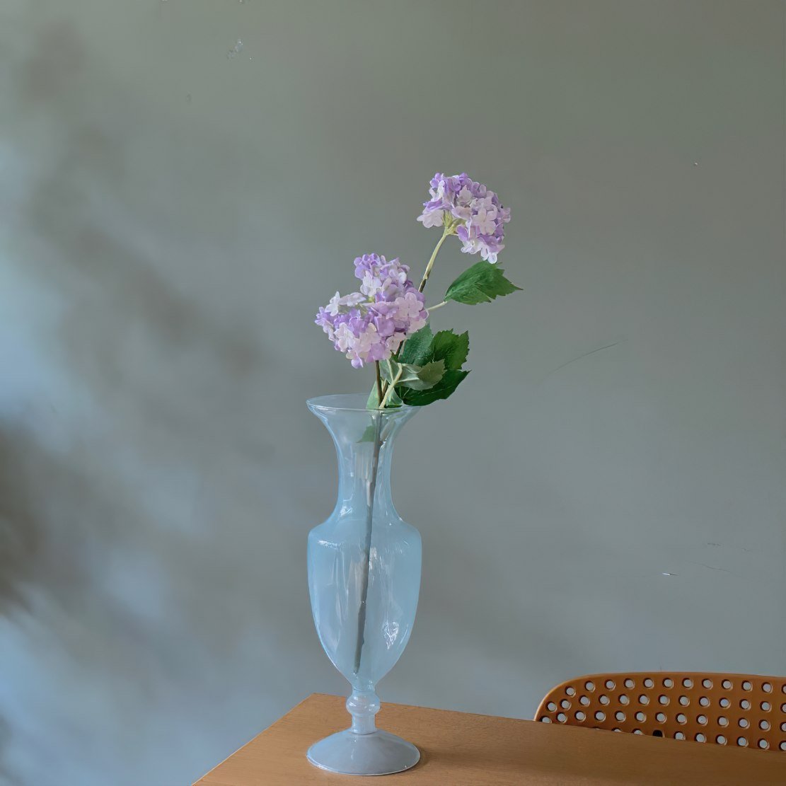 Blue romantic glass vase with purple flowers