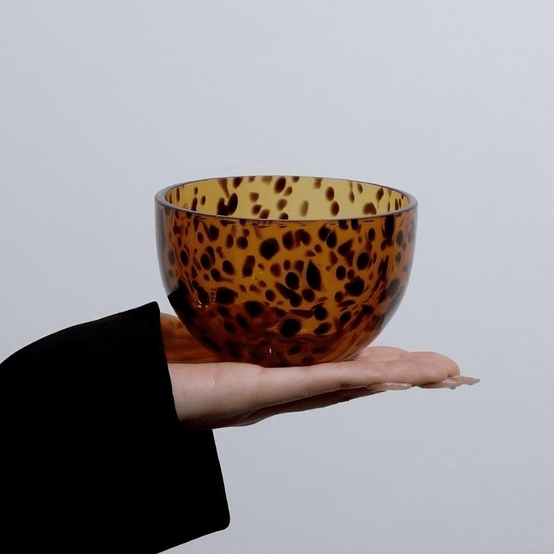 Brown glass tortoiseshell bowl on a hand