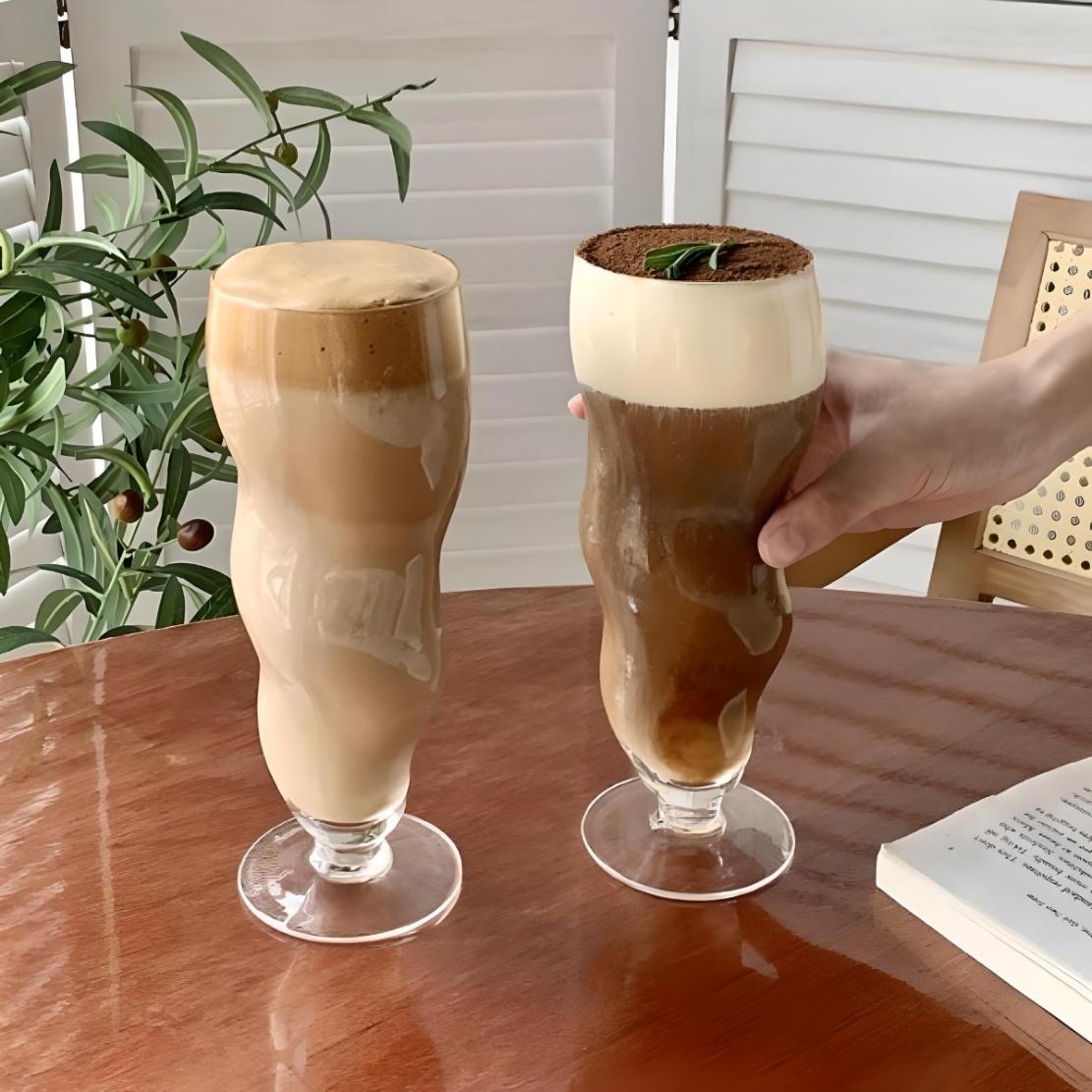 Tall, irregular trumpet shaped drinkware with coffee