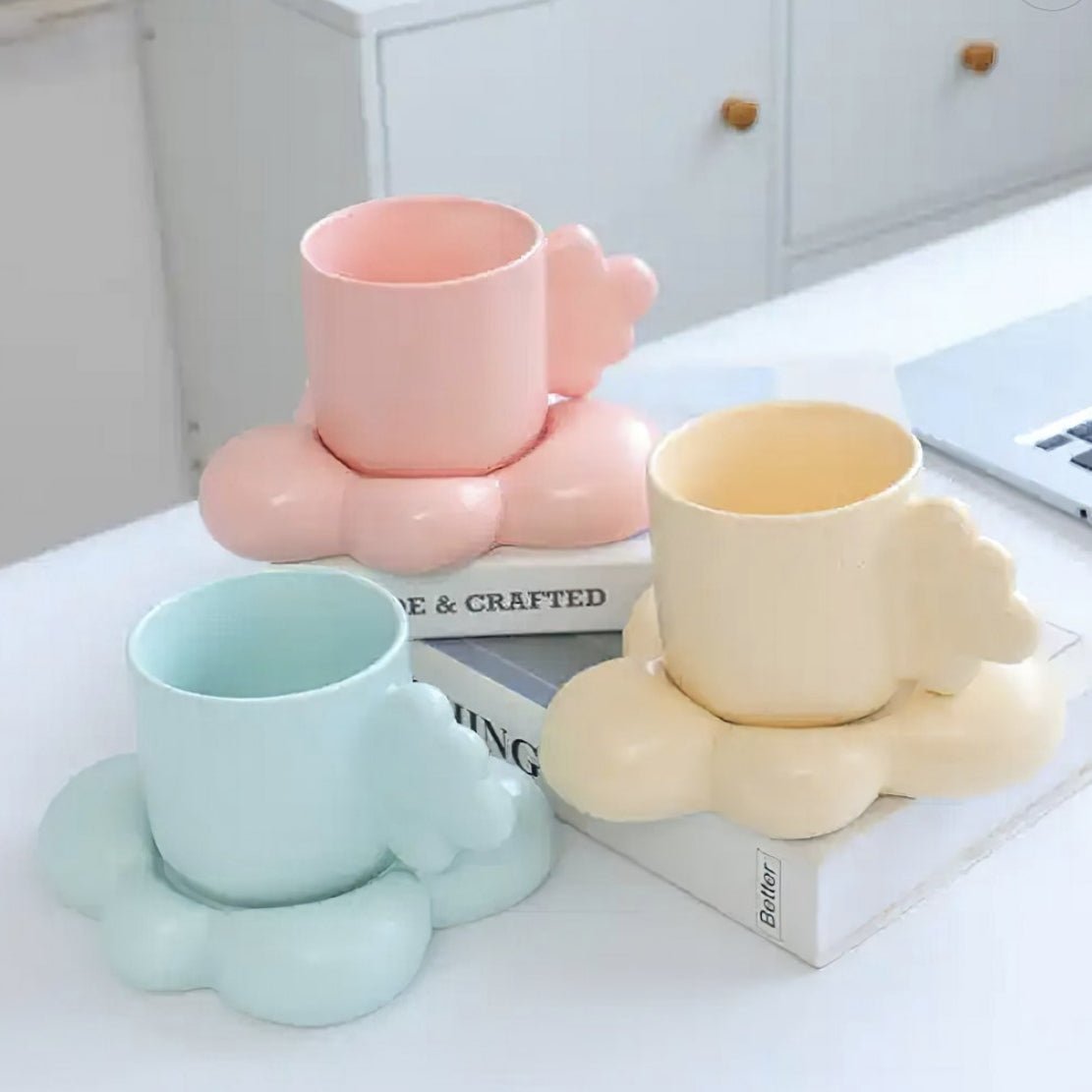 Pastel pink, blue & yellow cloud mug & saucer in a kitchen counter top